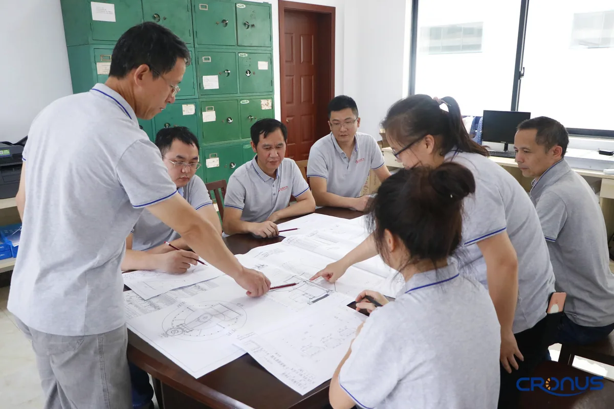 Cronus engineering team reviewing mill components